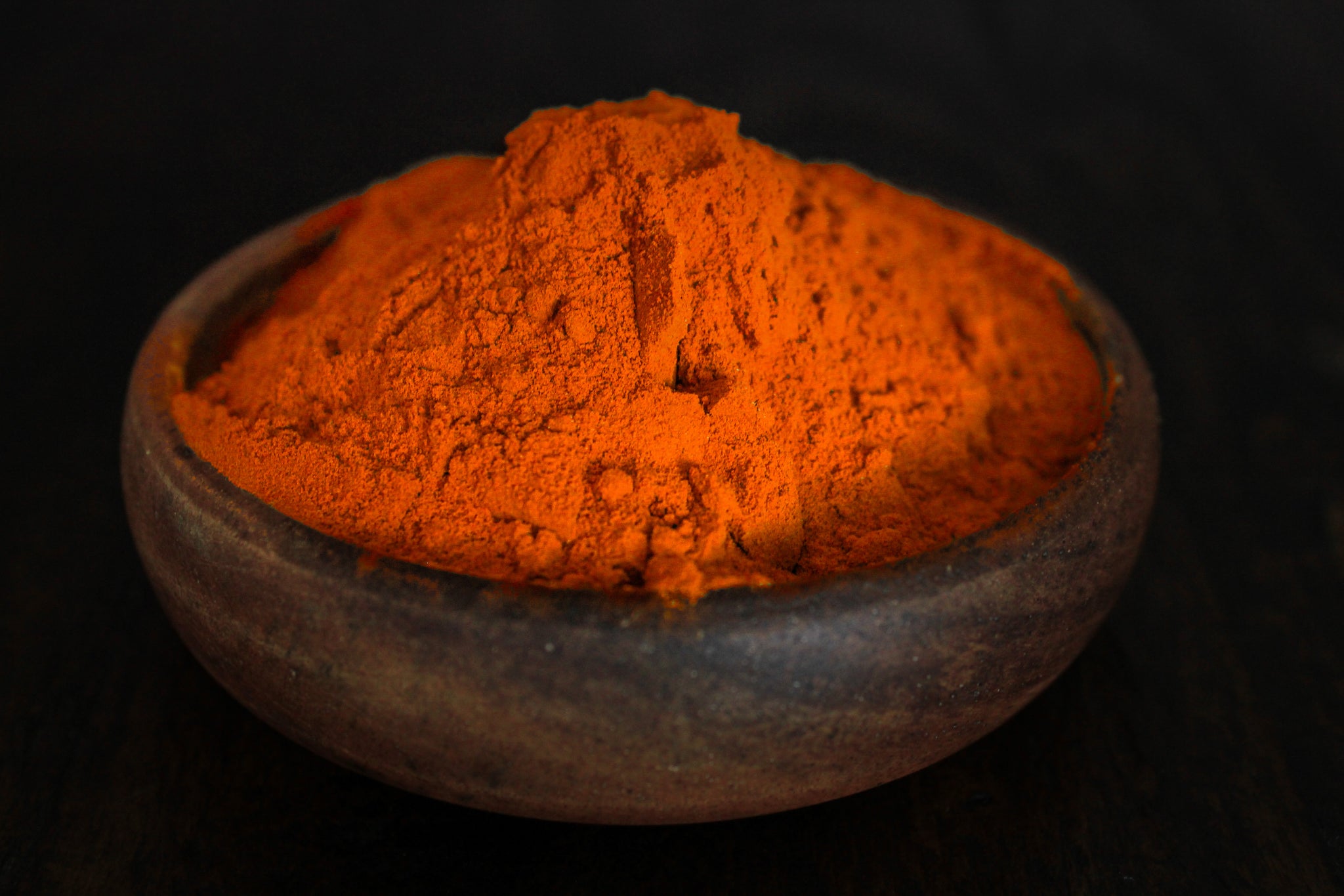 Strong potent curcumin extract shown in wooden bowl