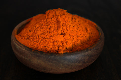 Strong potent curcumin extract shown in wooden bowl